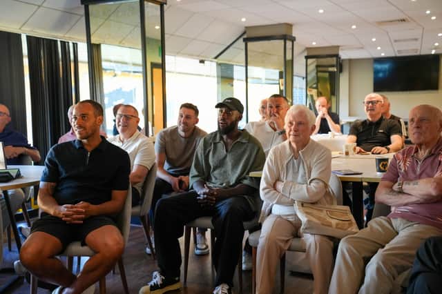 A room of different expressions watching the action back!