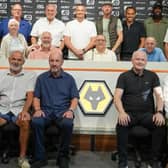 Players, staff and family line up in the Molineux media room