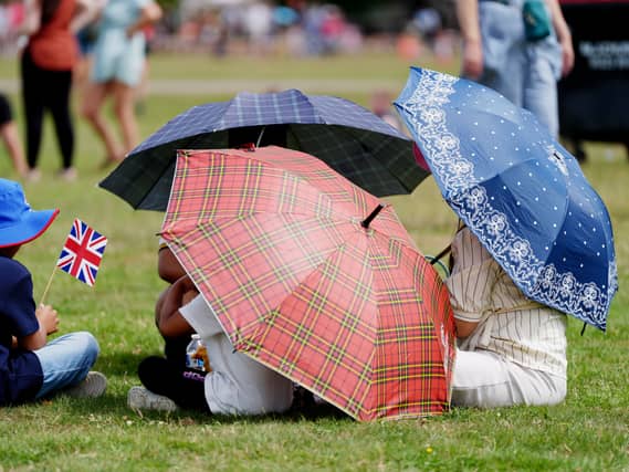 A family shelter under umbrellas