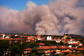 Smoke from a wildfire near homes in Spain