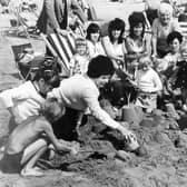 PICTURE FROM THE PAST: A memorial club's annual trip to Blackpool in August 1975 brought 3,500 people to the seaside on 70 coaches. On the beach, Janet Allen tried to build a sandcastle while neighbour John Jones made sure it didn't stay standing for long. Blackpool was, and remains, a favourite seaside destination for many Midlanders, with generations making the journey for a day by the sea. Do you remember those famous club outings?