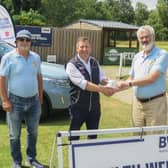 Builth Wells Rotarians, John Price and David England receiving a cheque from Tim Evans of Builth Wells Garages, on behalf of himself and brother Martyn.