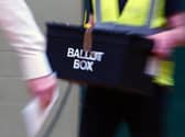 A ballot box is carried into an election count