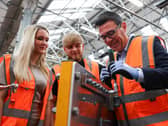 Andy Burnham with apprentices testing his engineering skills