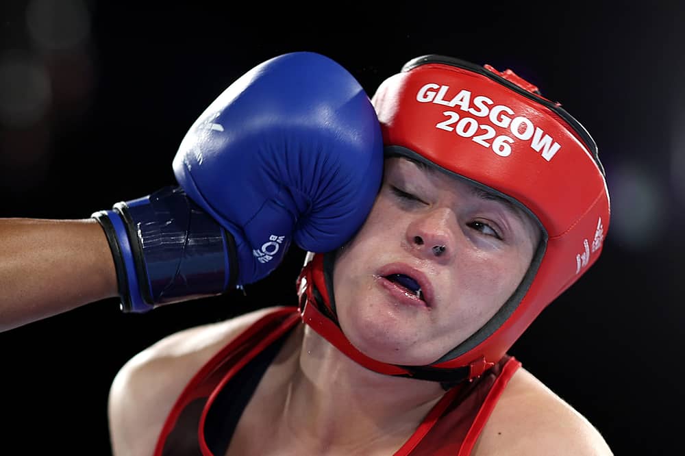 Mary Kate Smith of Team England is punched by Patricia Mbata of Team Nigeria during the Women's 75kg Quarter-Final match on day five of the Glasgow 2026 Commonwealth Games at SEC Centre
