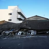 Vehicles are crushed under collapsed buildings in Yatsushiro