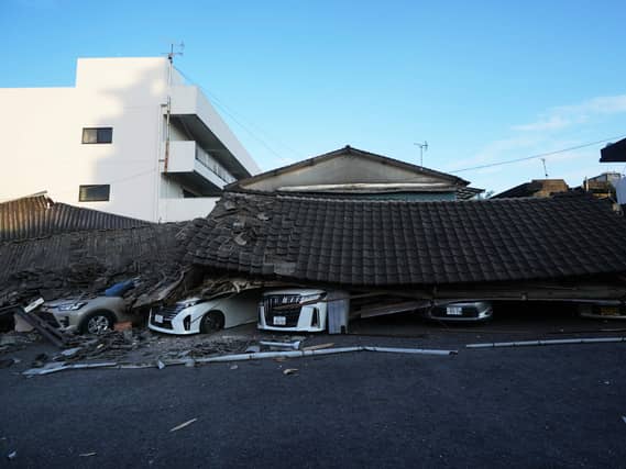 Vehicles are crushed under collapsed buildings in Yatsushiro