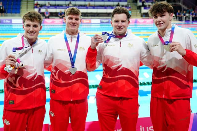 Edward Mildred, Oliver Morgan, Adam Ramsey-Peaty, and Jacob Mills of England celebrate with their silver medals after the Men's 4 X 100m Medley Relay Final at Tollcross International Swimming Centre during day six of the 2026 Commonwealth Games in Glasgow
