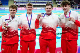 Edward Mildred, Oliver Morgan, Adam Ramsey-Peaty, and Jacob Mills of England celebrate with their silver medals after the Men's 4 X 100m Medley Relay Final at Tollcross International Swimming Centre during day six of the 2026 Commonwealth Games in Glasgow