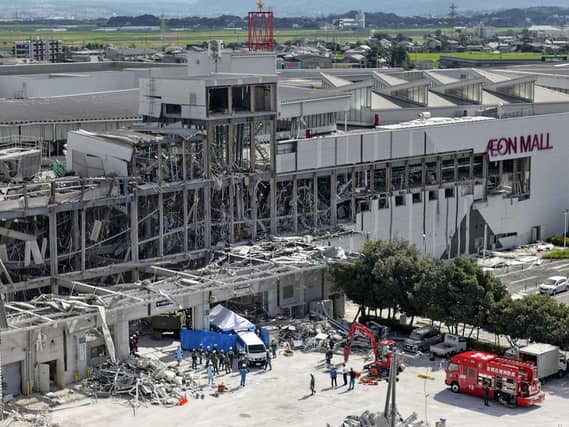 In this aerial image taken with a drone, responders work outside AEON Mall Kumamoto