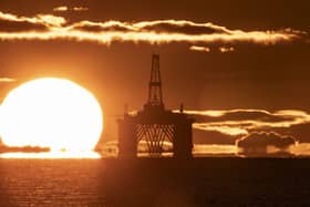 Oil platform with sun rising in background