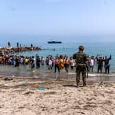 Spanish soldiers block access to the beach for people crossing from Morocco into the Spanish enclave of Ceuta