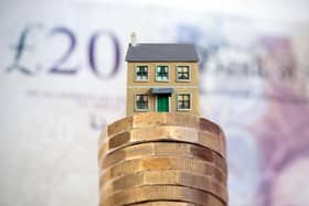 House on top of a pile of pound coins