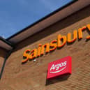Sainsbury's and Argos logos outside a Sainsbury's supermarket.