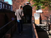 A man walking into a polling station
