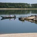 People watch the wreckage of a Second World War German warship, emerged due to the drought, in front of Djerdap II, a large dam on the Danube River, between Romania and Serbia, near Prahovo, Serbia
