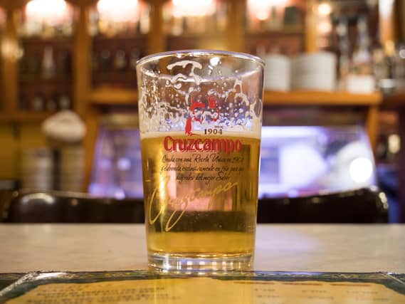 A pint of Cruzcampo on a bar
