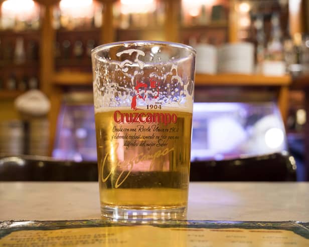 A pint of Cruzcampo on a bar