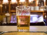 A pint of Cruzcampo on a bar