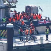A group of people thought to be migrants are brought in to the Border Security Command compound in Dover