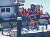 A group of people thought to be migrants are brought in to the Border Security Command compound in Dover