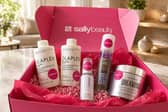 A selection of salon-quality haircare products from Sally Beauty, including Olaplex, Color Wow, Wella and Wunderbar, styled as part of an at-home haircare routine.