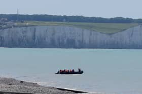 A small boats hugs the coastline near Ault in France as people thought to be migrants begin an attempt to cross the Channel