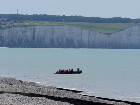 A small boats hugs the coastline near Ault in France as people thought to be migrants begin an attempt to cross the Channel