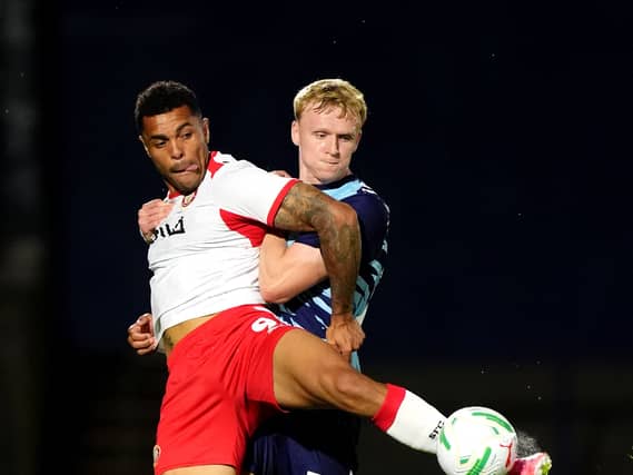 Stevenage’s Josh Magennis (left) and Wycombe’s Connor Taylor battle for the ball