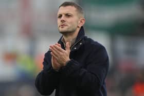Jack Wilshere applauds the fans