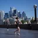 A view of the City of London, with a jogger in the foreground