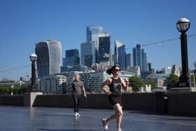A view of the City of London, with a jogger in the foreground