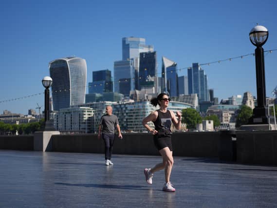 A view of the City of London, with a jogger in the foreground