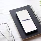 Plus500 logo on phone
