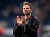 Tom Cleverley applauds the fans