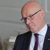 John Swinney tilting his head to one side