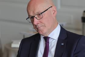 John Swinney tilting his head to one side