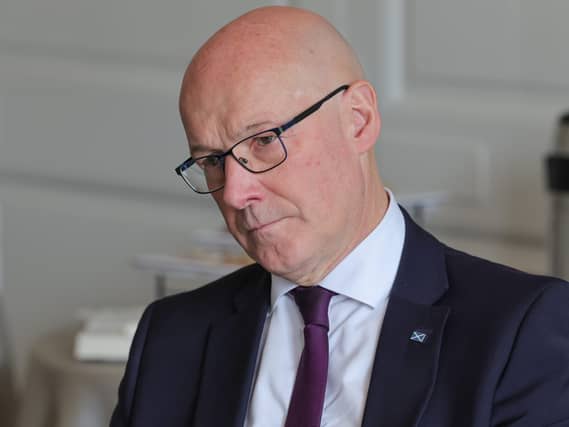 John Swinney tilting his head to one side