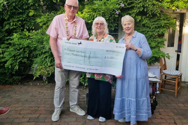 Liz Bird from the Bridgnorth Food Bank accepting a cheque from Mayor Chris Aked and Mrs Gillie Aked.