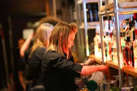 Bar staff serving customers