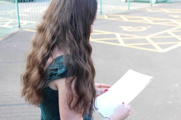 A Newtown High School student looks at her results