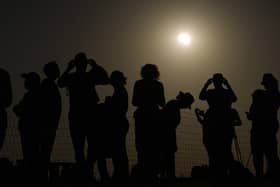 People watching the solar eclipse near Stonehenge in Wiltshire