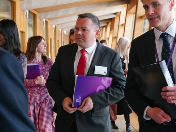 Joe Fagan walking through a corridor at Holyrood