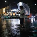 Torrential rain floods a road, causing a car to stall, in Ichikawa, Chiba prefecture, Japan,