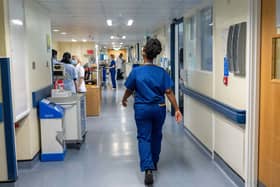 Hospital worker walking through a hospital corridor