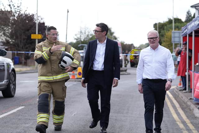 Prime Minister Andy Burnham (centre) and West Midlands Mayor Richard Parker speaking to West Midlands Fire Service Chief fire officer Simon Tuhill in Stourbridge following the fires