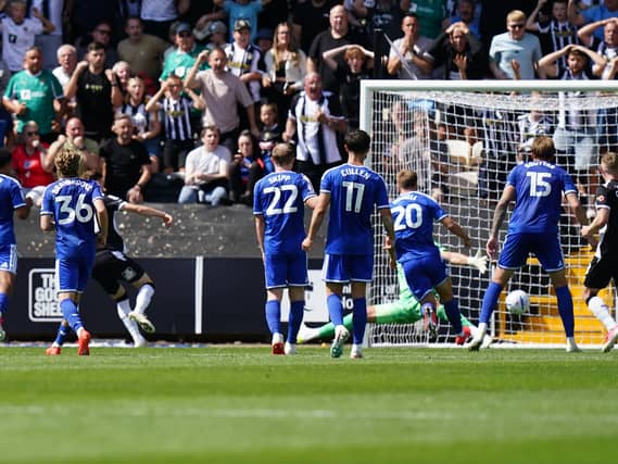 Conor Grant, third from left, scores for Notts County