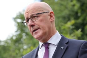 John Swinney cocking his head to one side as he speaks