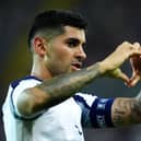Cristian Romero makes a heart shape with his hands