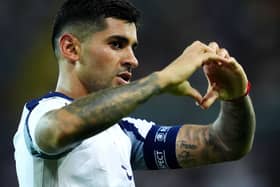 Cristian Romero makes a heart shape with his hands